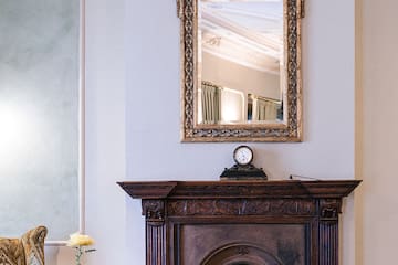 a mirror above a fireplace