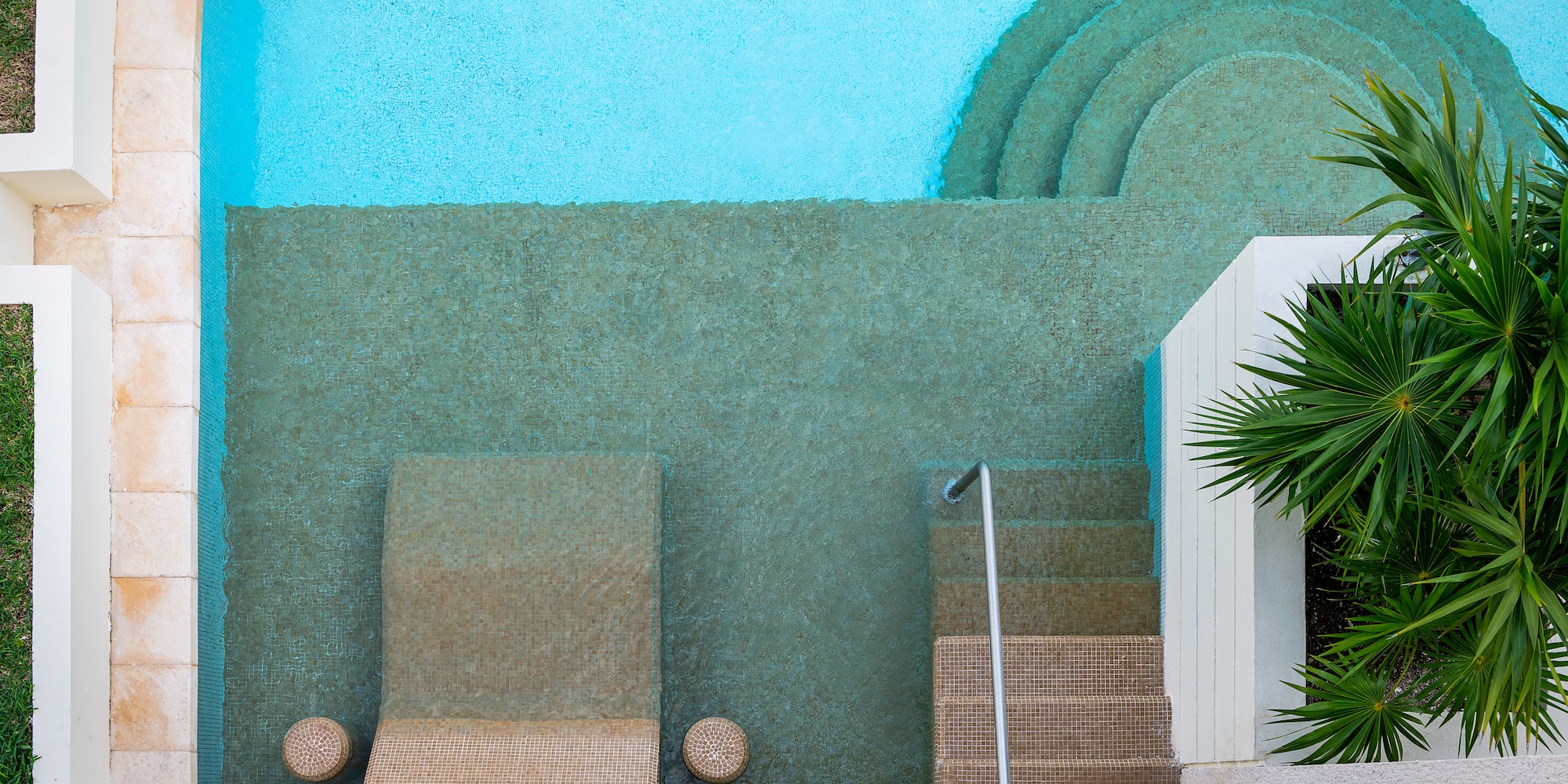 a pool with steps and chairs