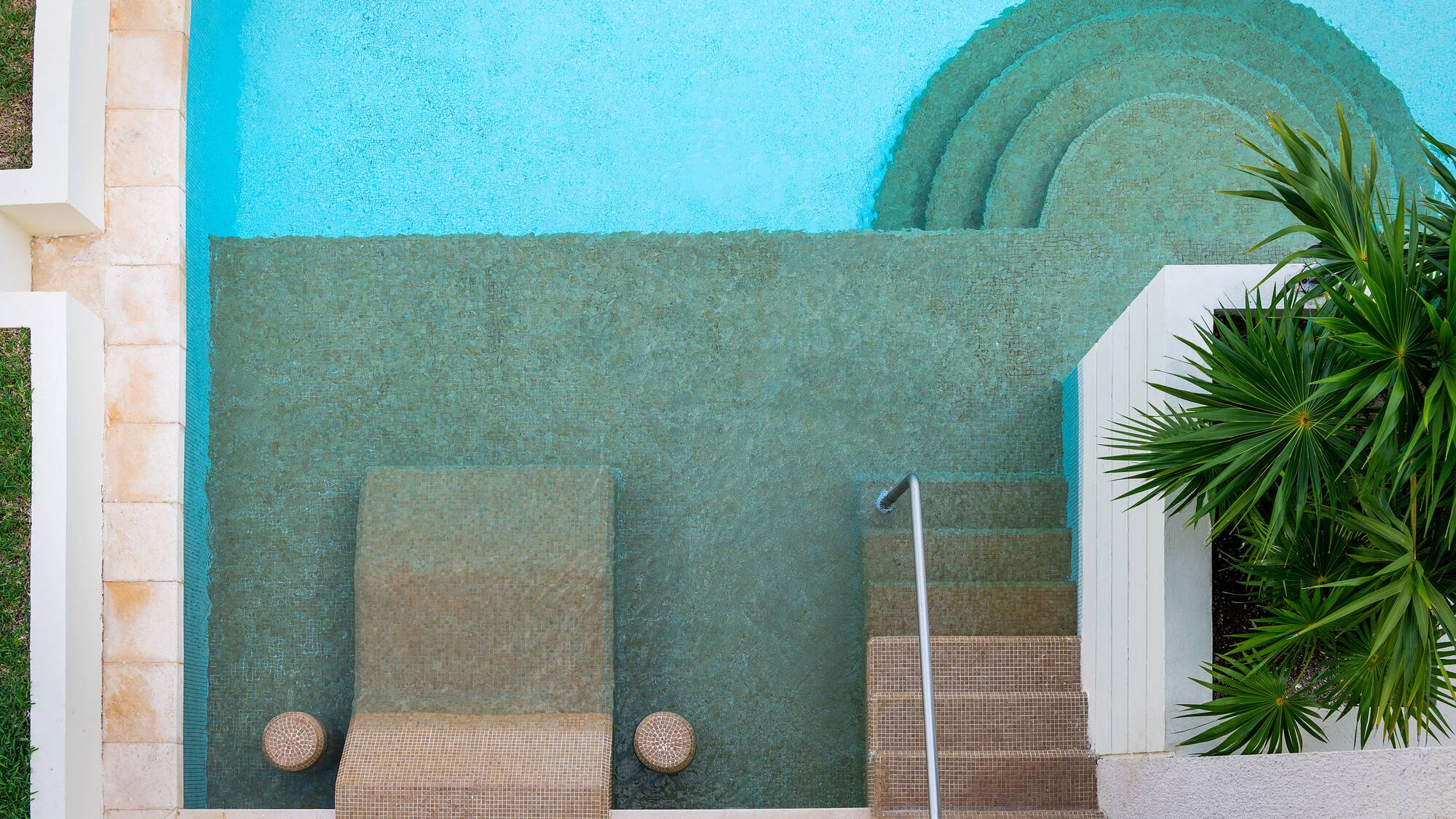 a pool with steps and chairs