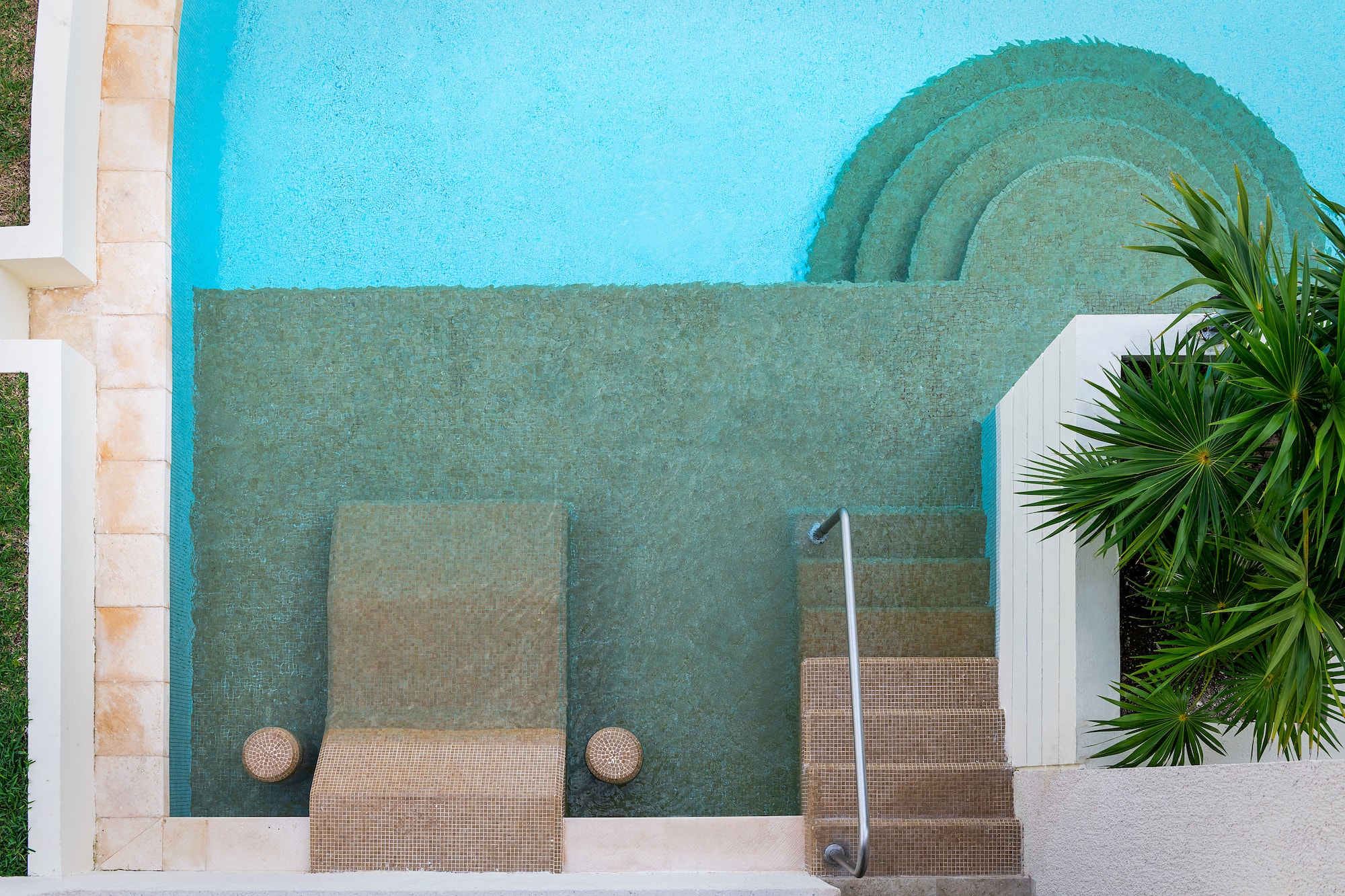 a pool with steps and chairs