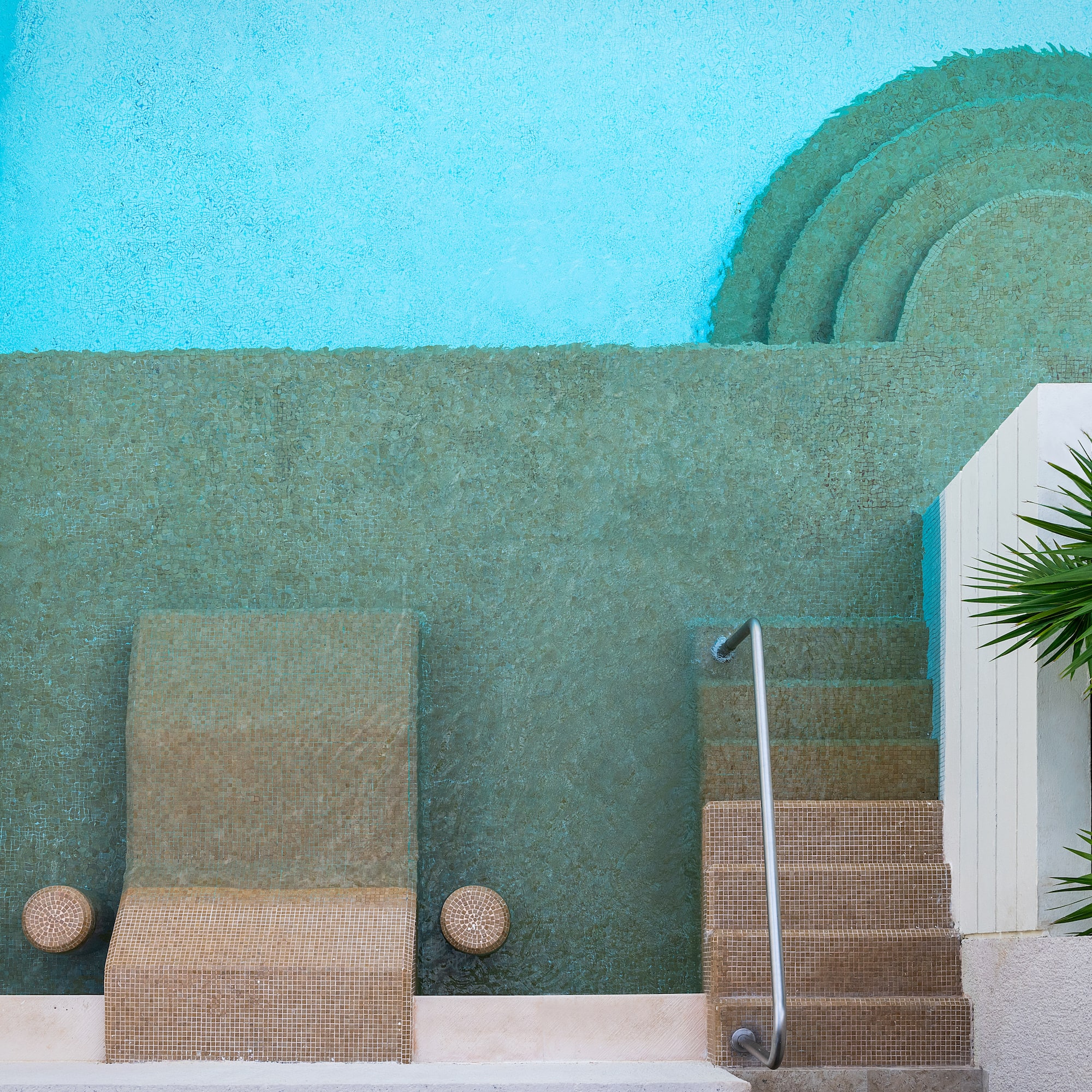 a pool with steps and chairs