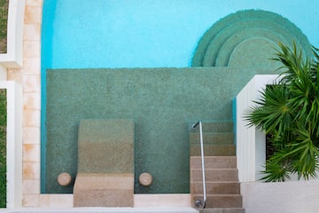 a pool with steps and chairs