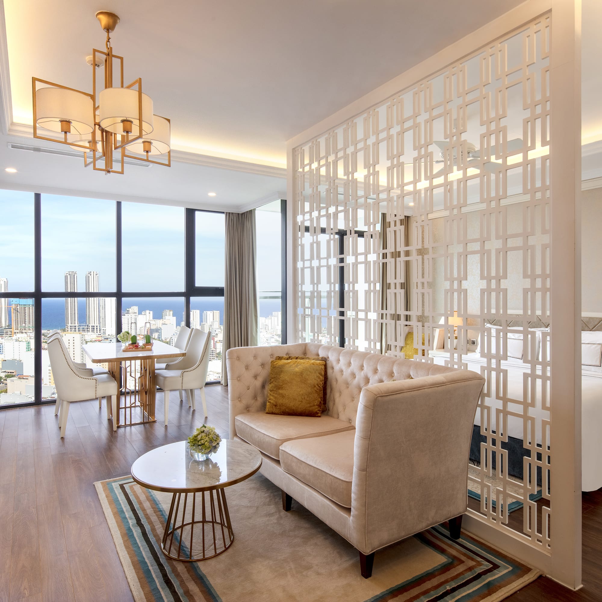 a room with a couch and a table and chairs