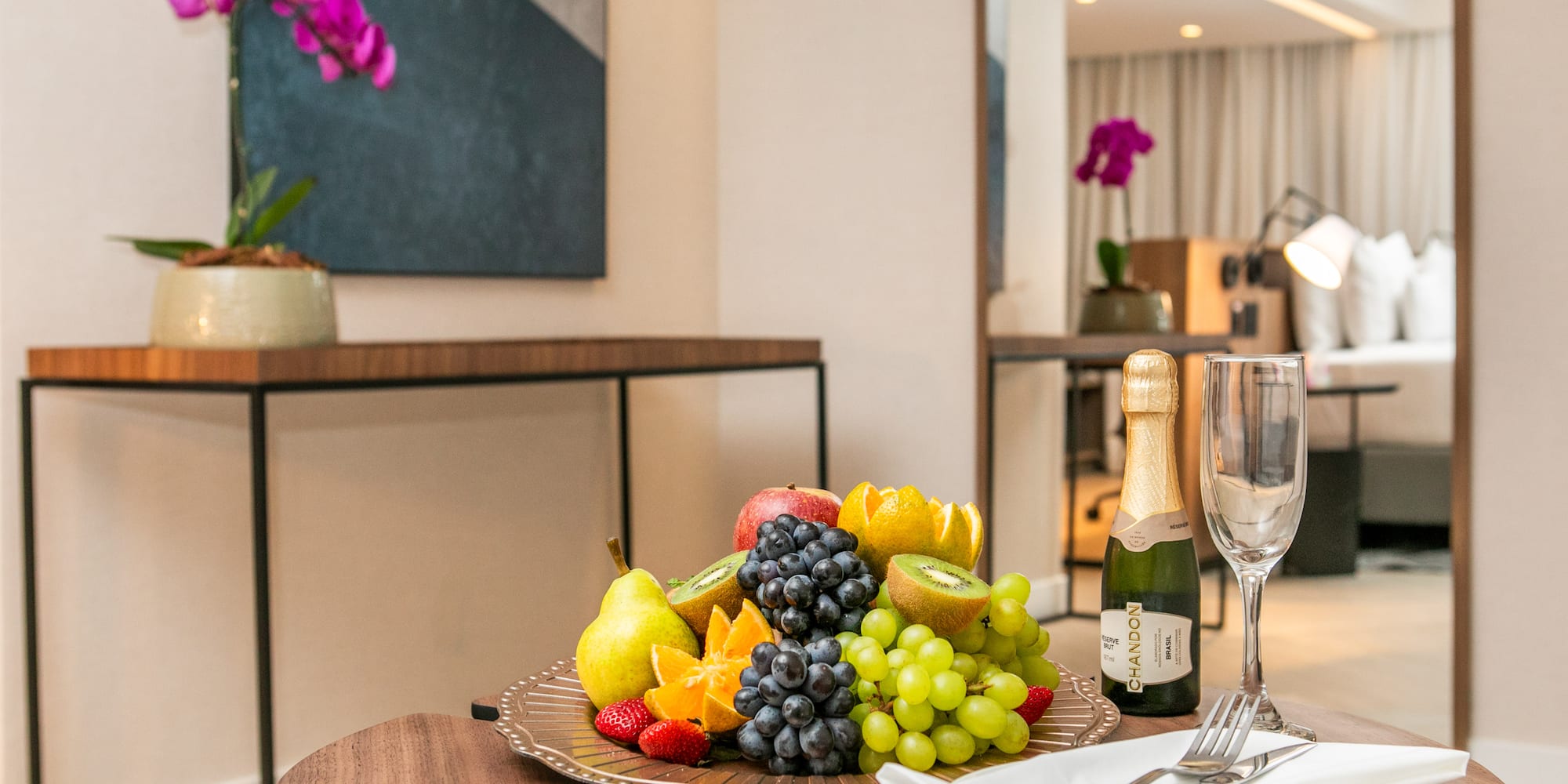 a plate of fruit and champagne on a table