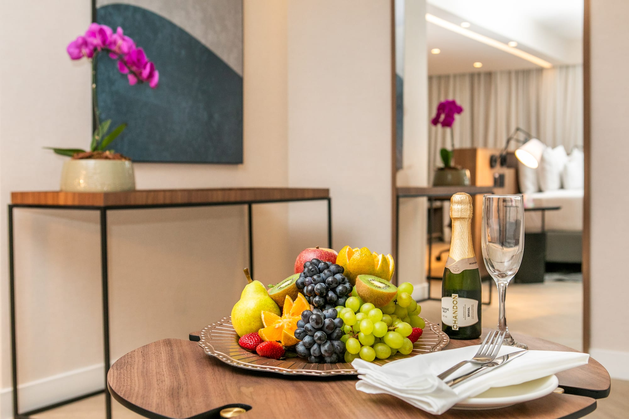 a plate of fruit and champagne on a table