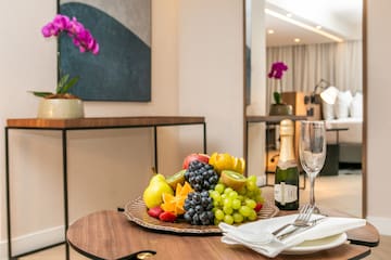 a plate of fruit and champagne on a table