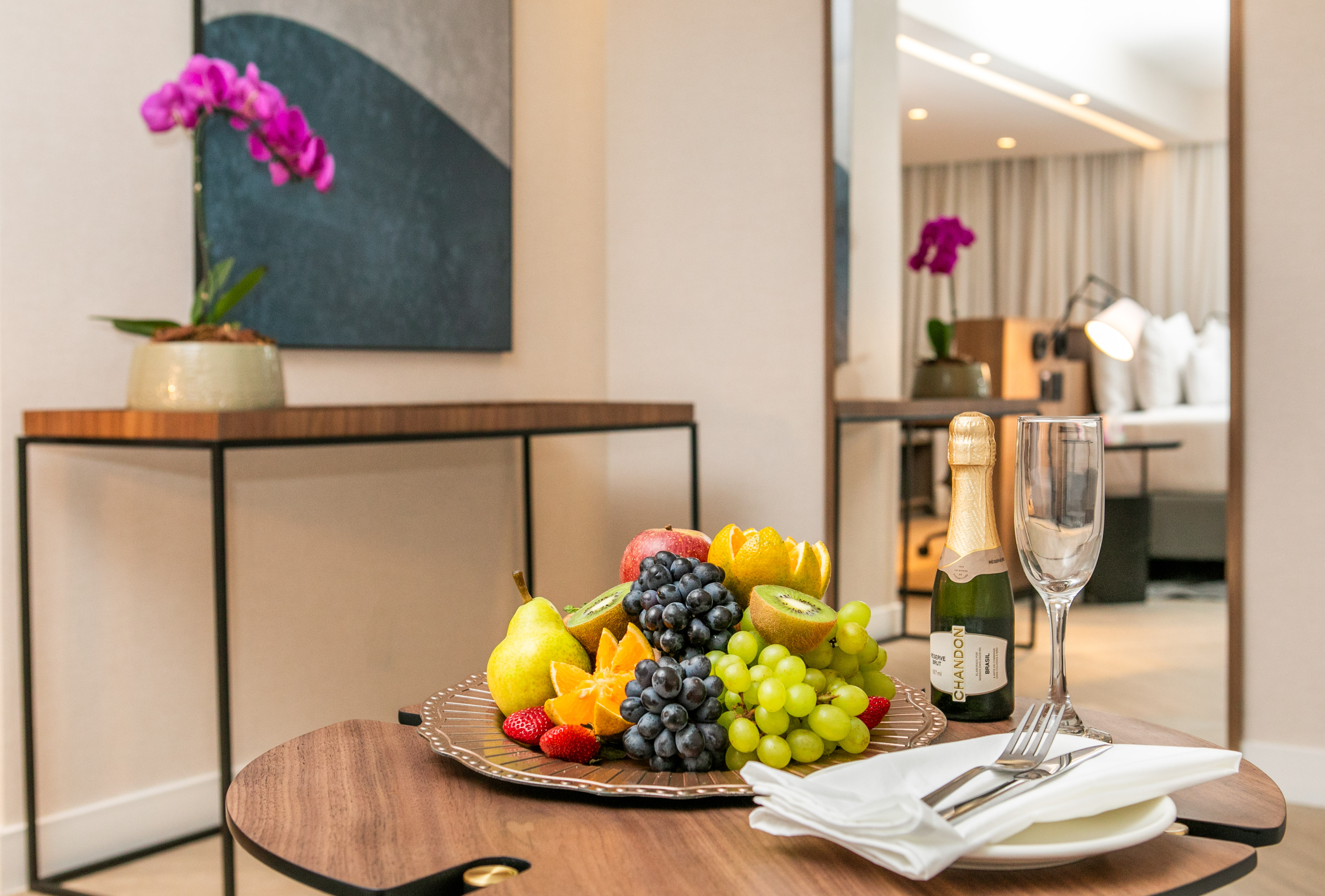 Hotel welcome amenity: fruit platter, Chandon champagne, silverware, orchid.
