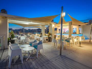 a patio with tables and chairs