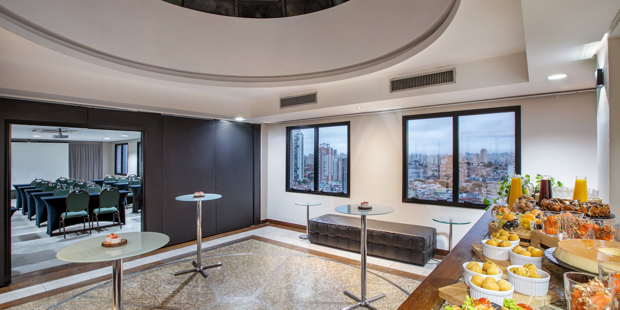 a room with a large window and a large table with food on it