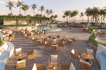 a group of people sitting at tables and chairs outside