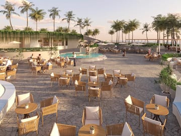 a group of people sitting at tables and chairs outside