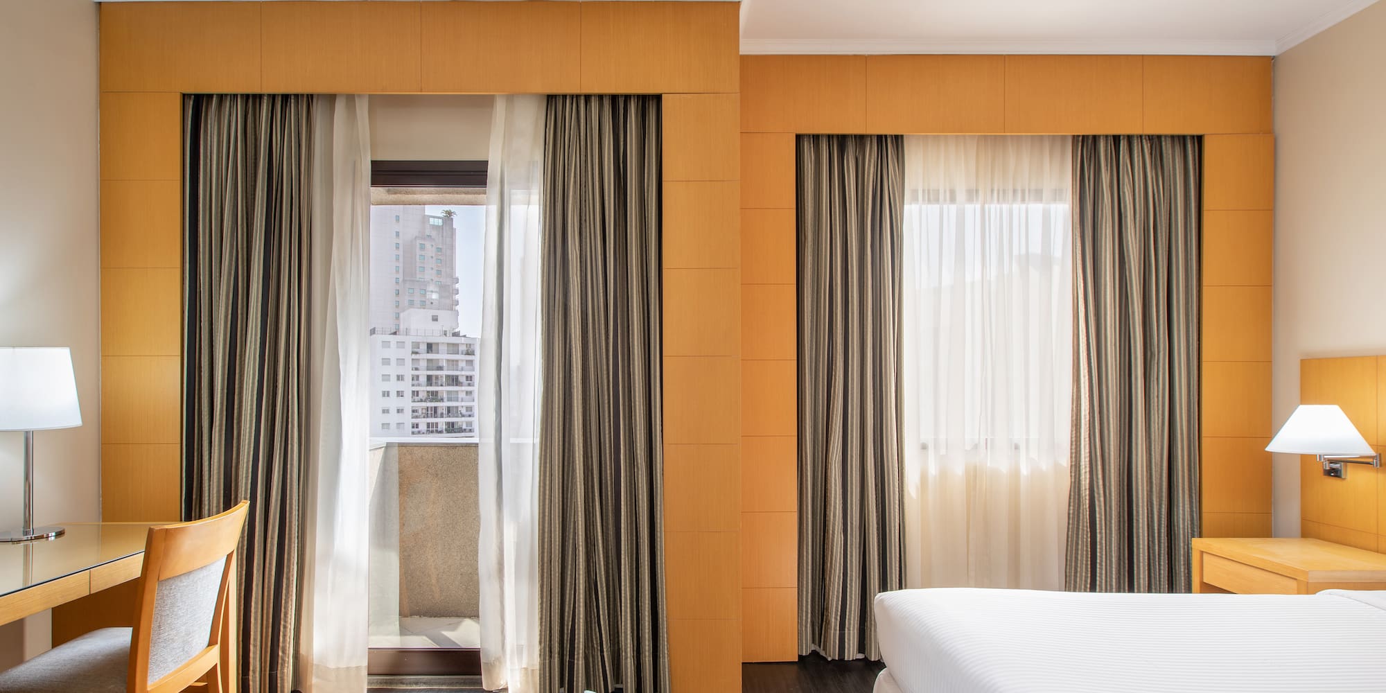 a room with a bed and curtains