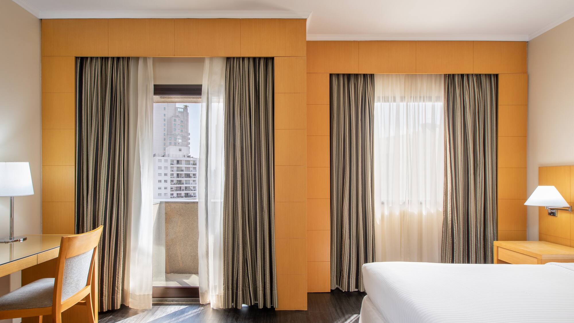 a room with a bed and curtains