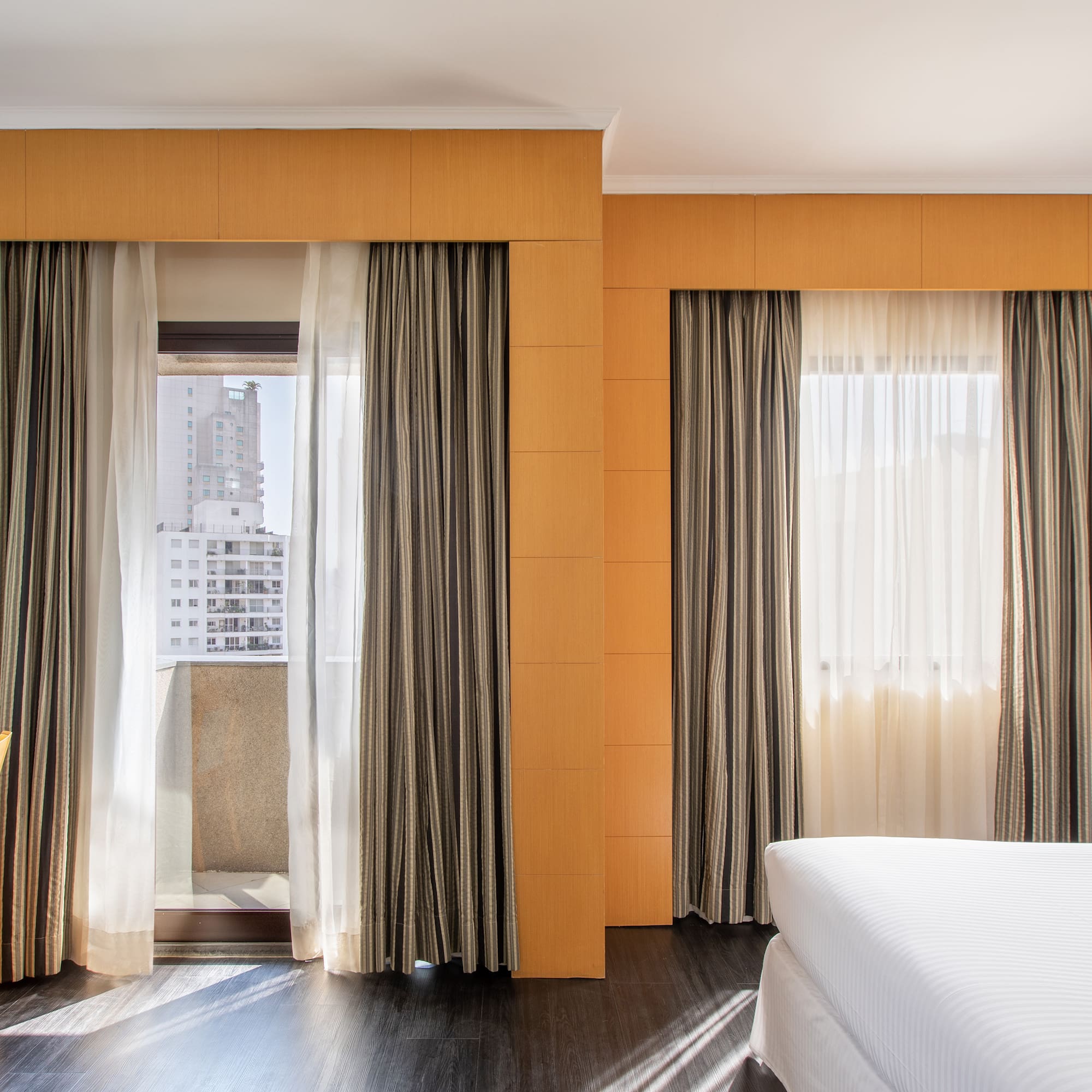 a room with a bed and curtains