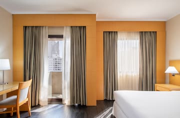 a room with a bed and curtains