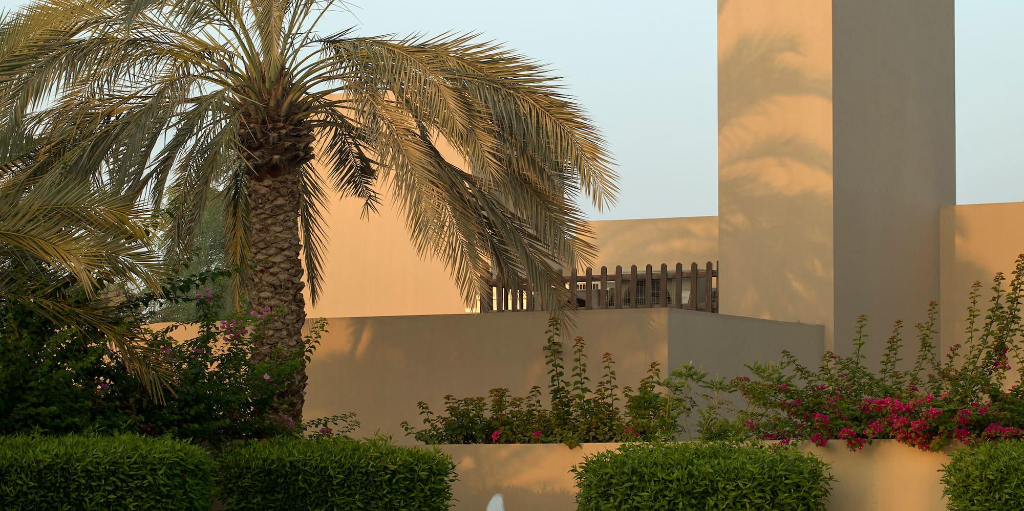 a fountain in a courtyard with palm trees