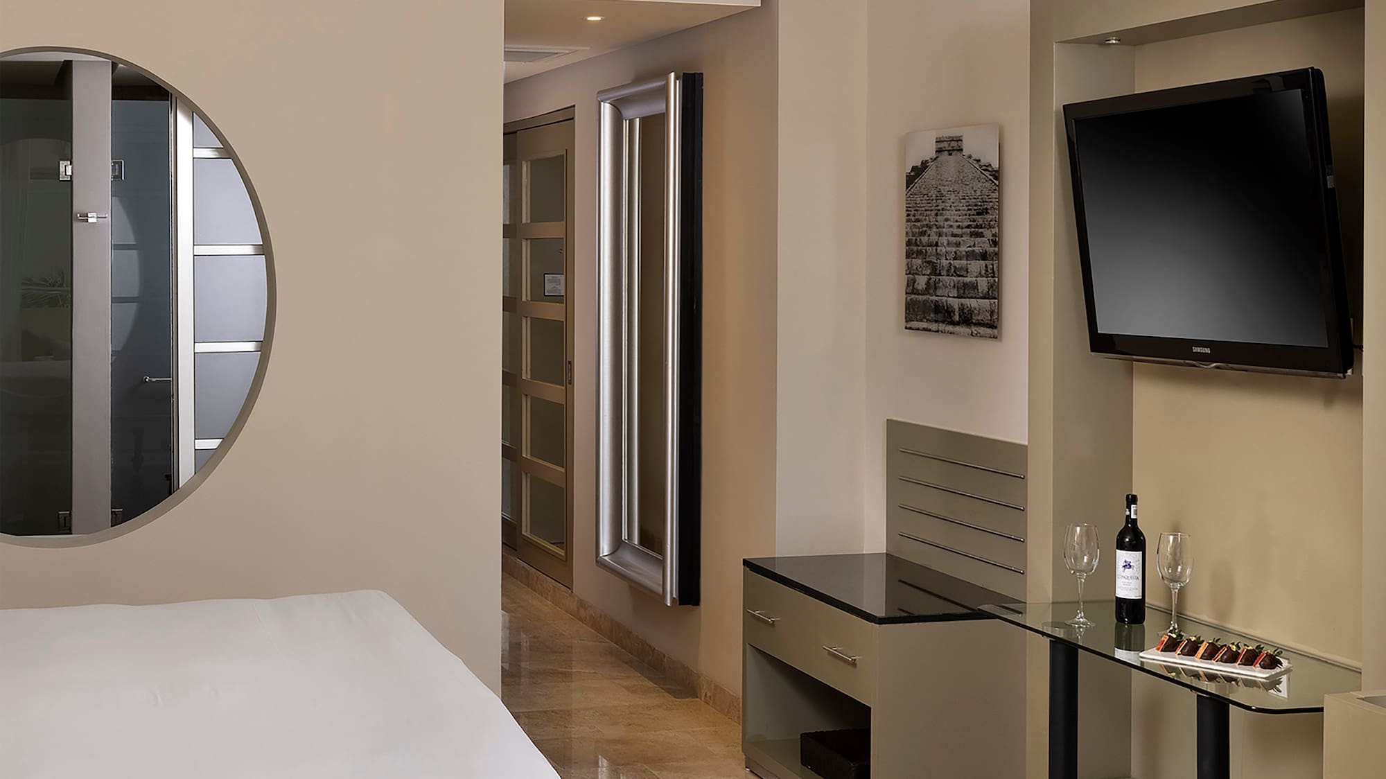 a room with a bed and a television