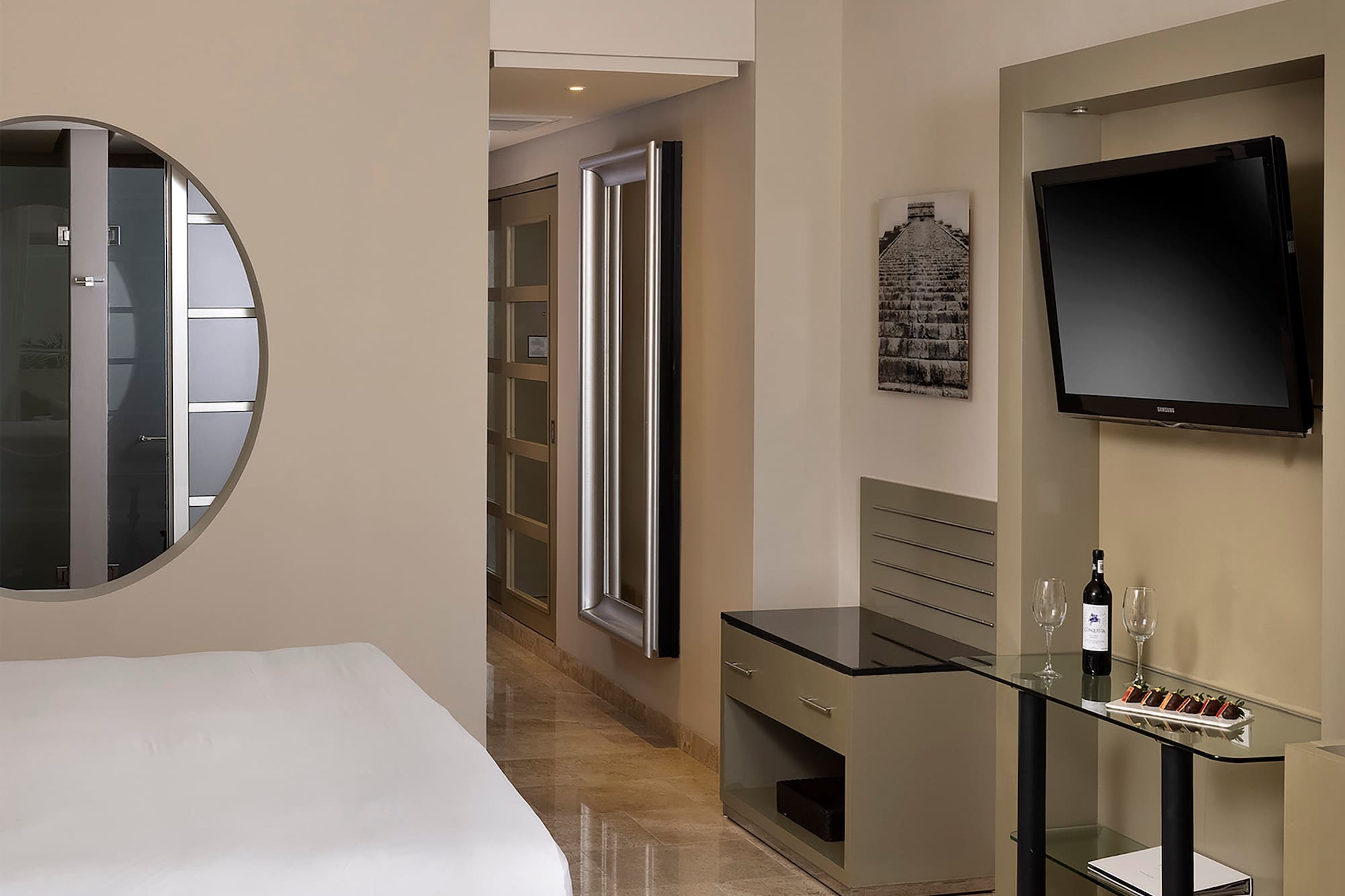 a room with a bed and a television