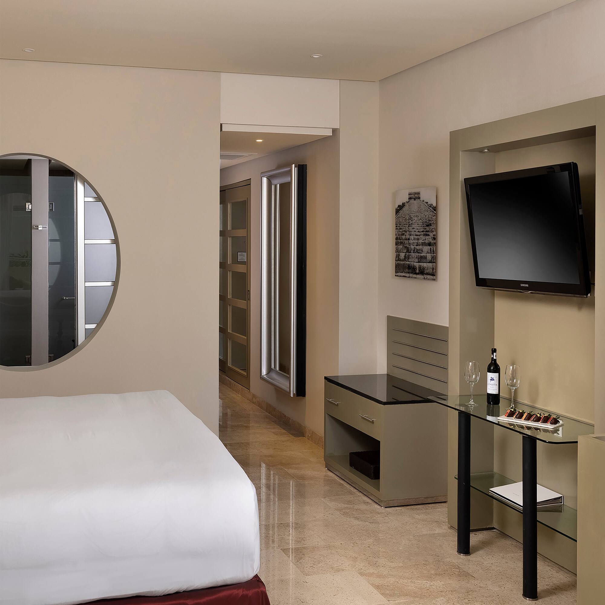 a room with a bed and a television