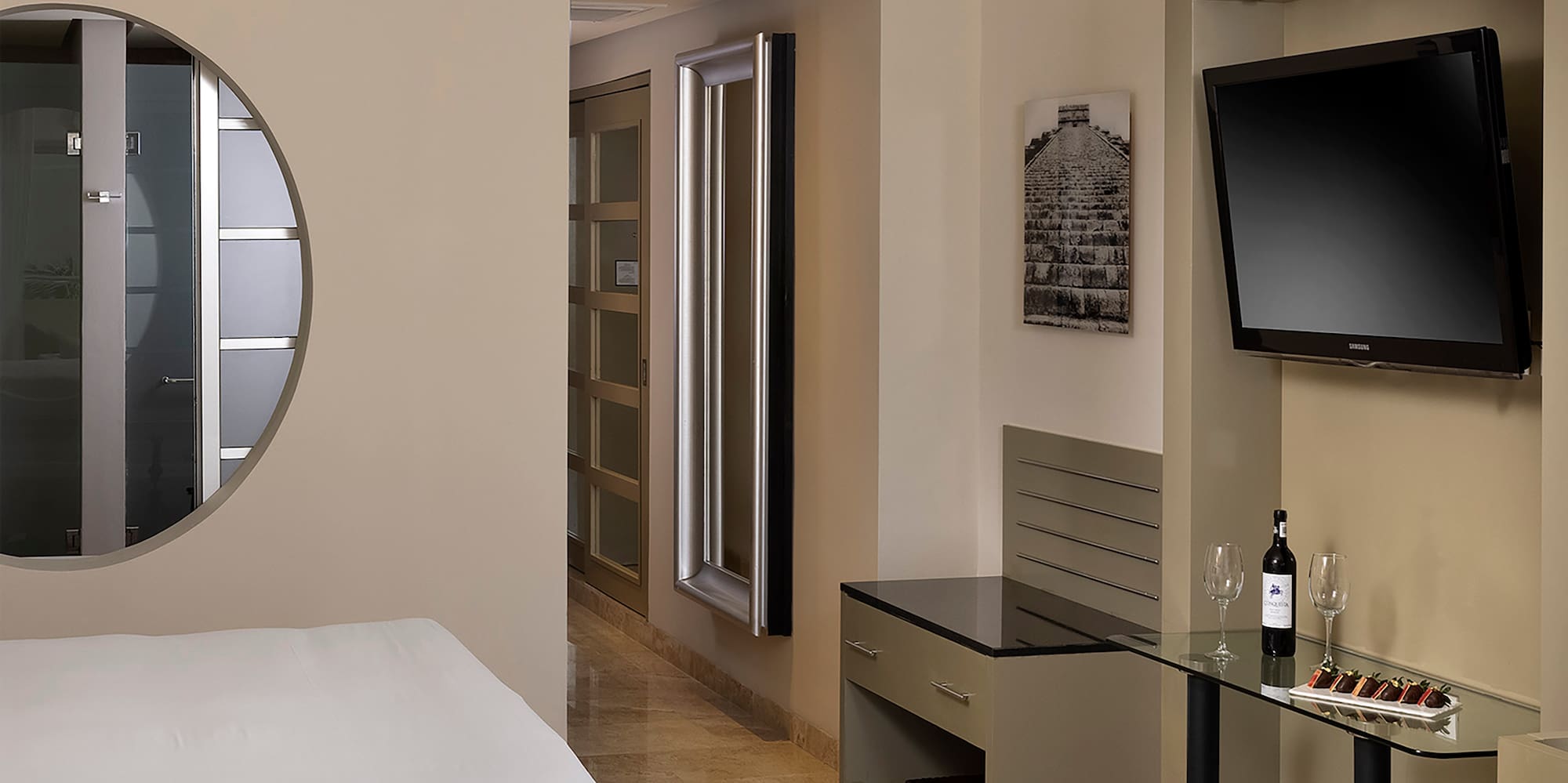 a room with a bed and a television