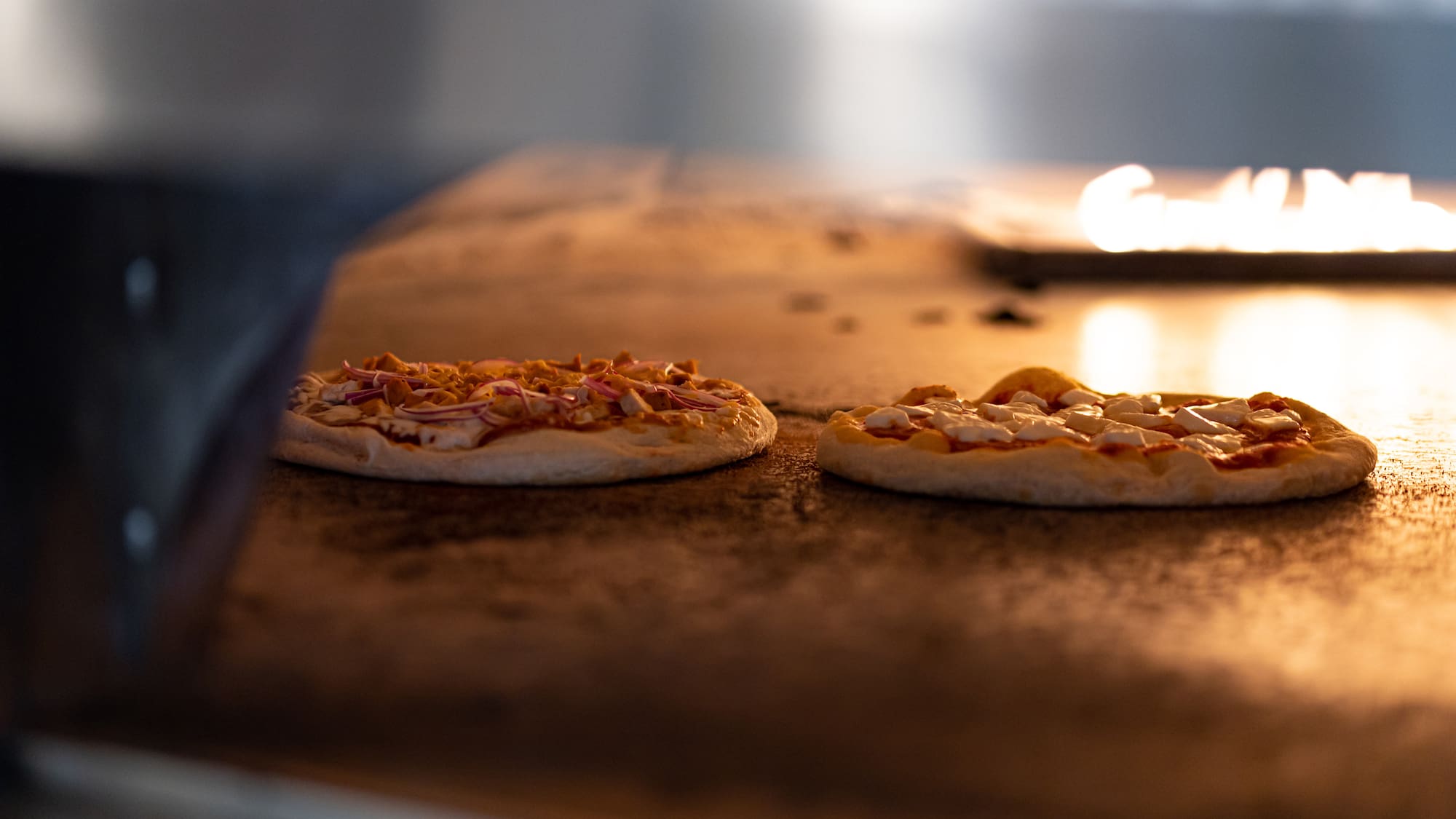 a couple of pizzas on a counter