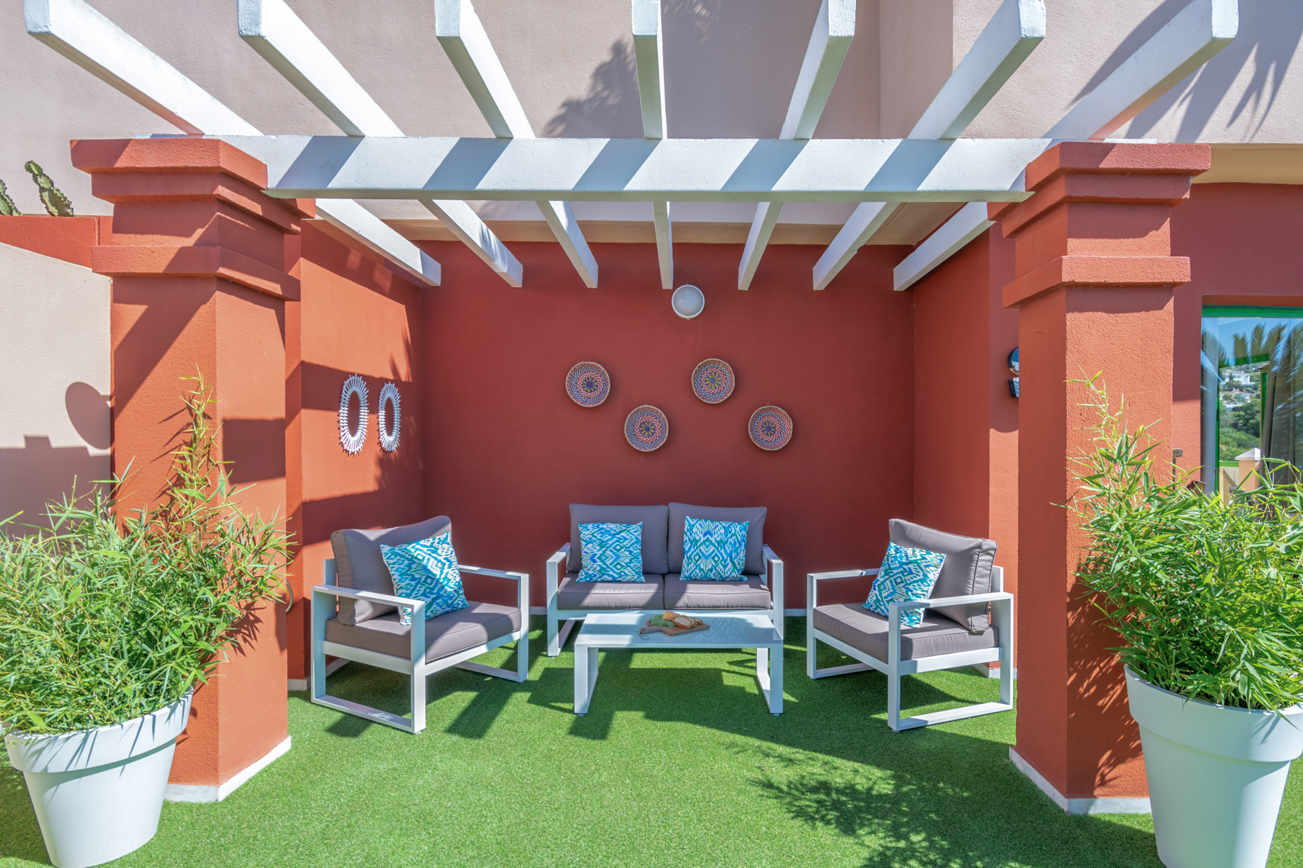 a patio with chairs and a table