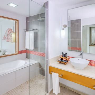 a bathroom with a glass shower door and sink