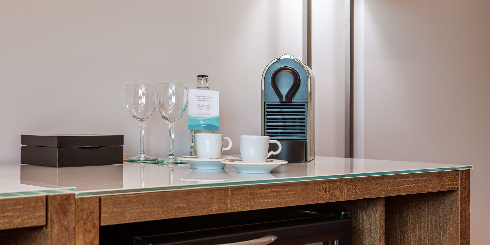 a coffee cup and wine glasses on a counter