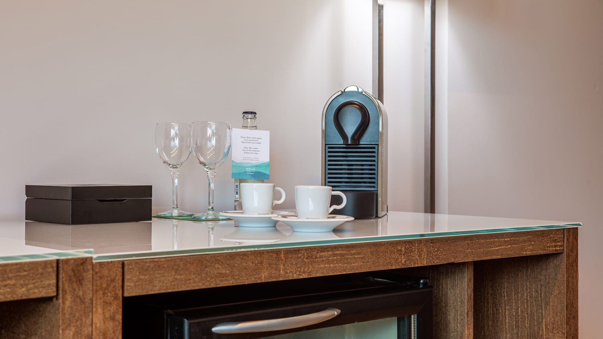 a coffee cup and wine glasses on a counter