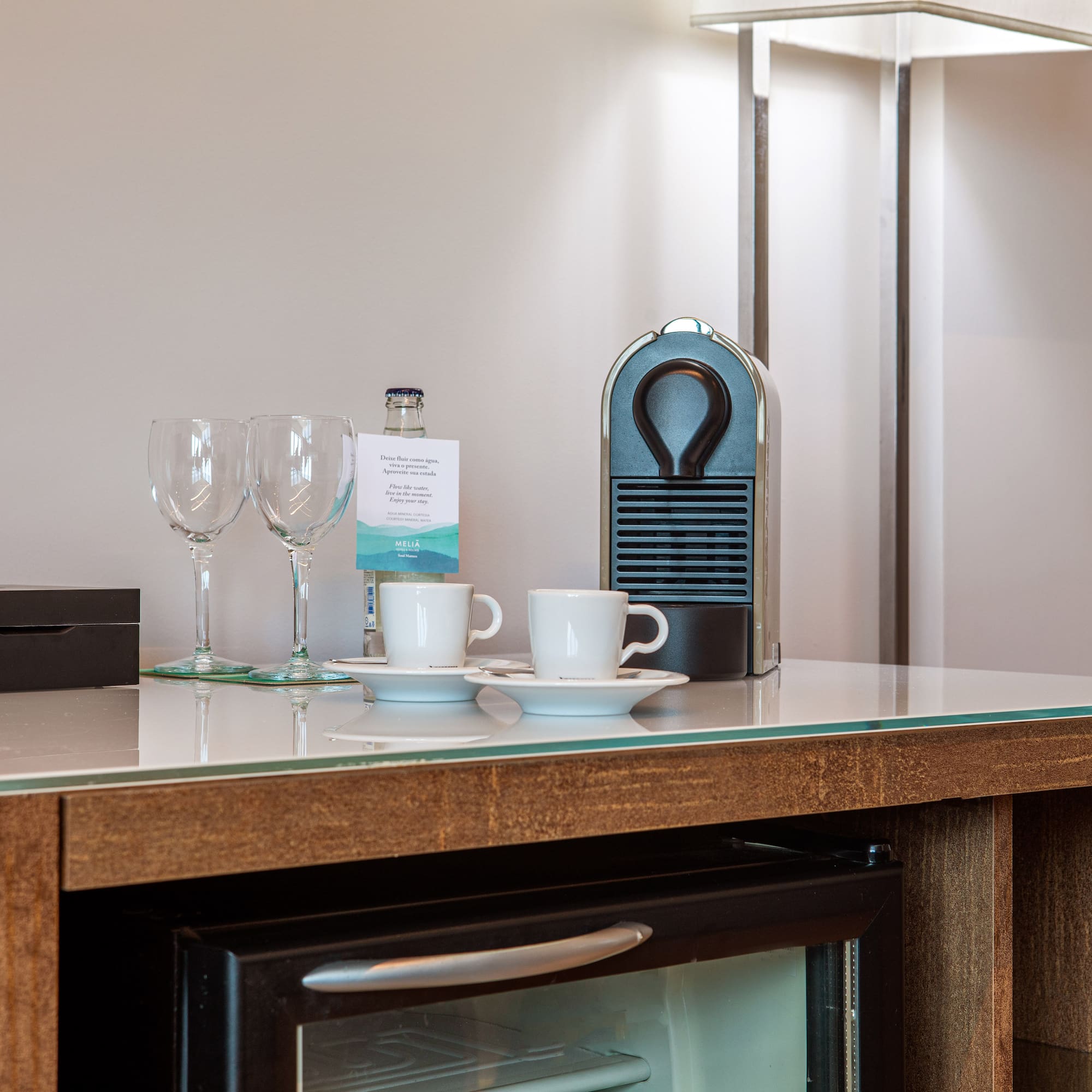 a coffee cup and wine glasses on a counter