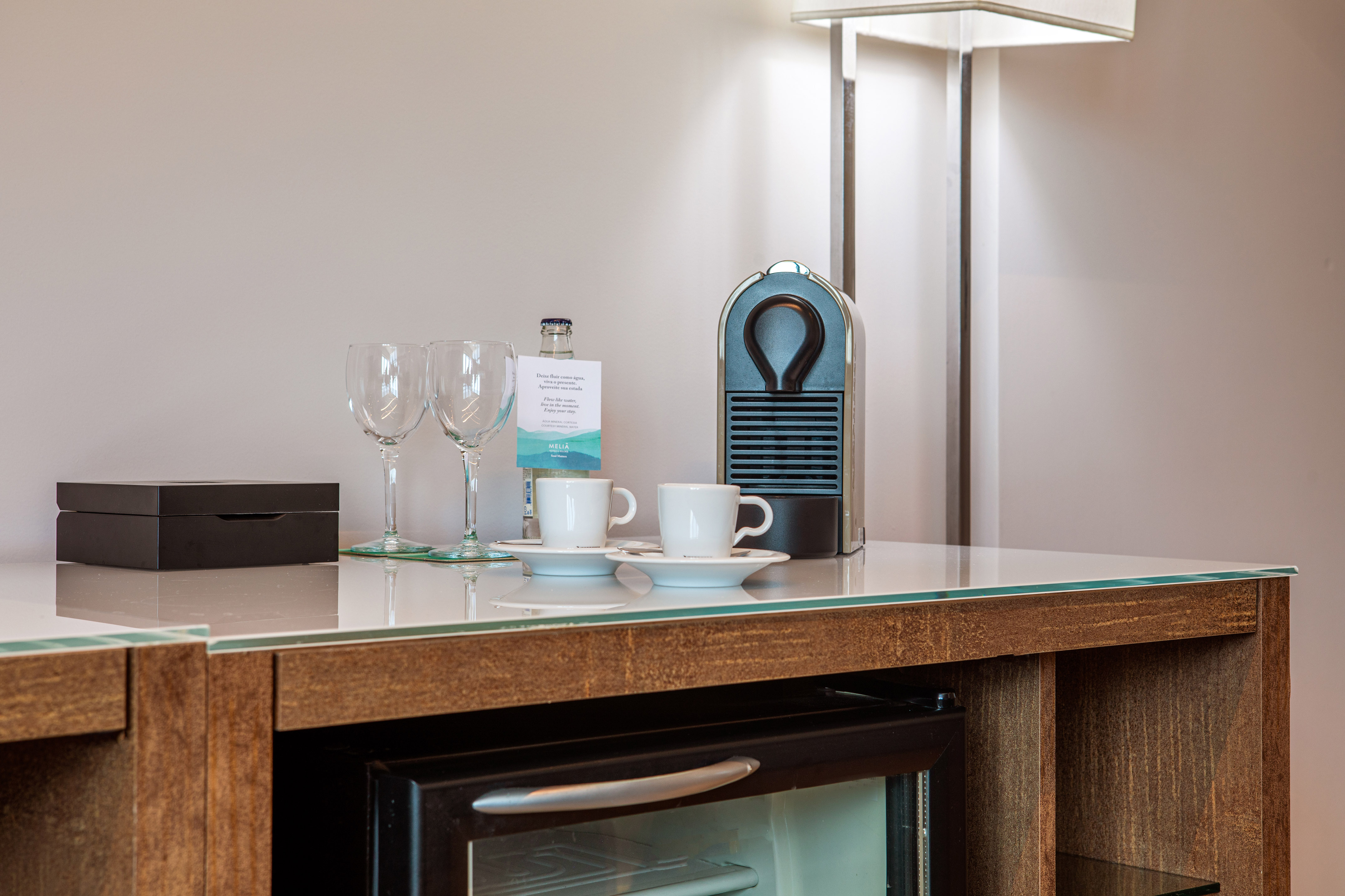 a coffee cup and wine glasses on a counter