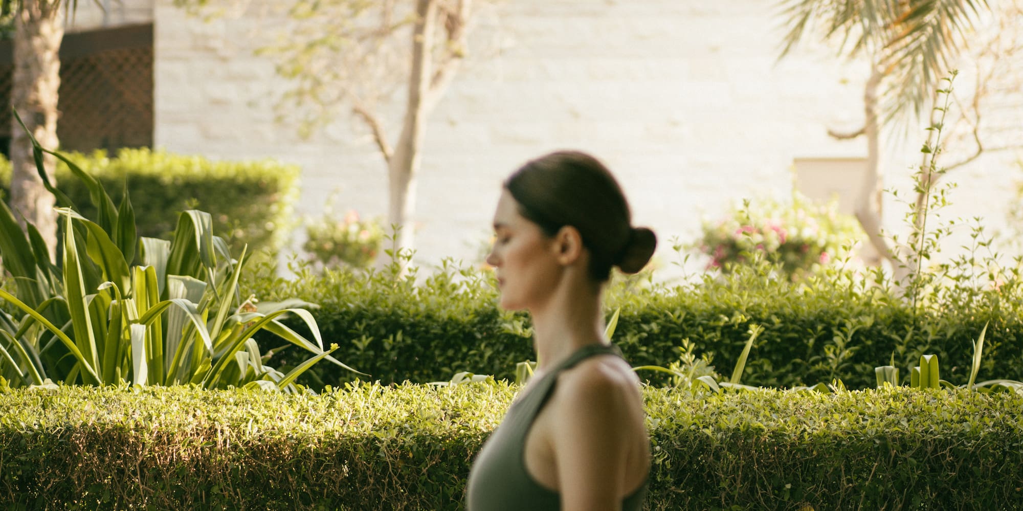 a woman sitting on a mat outside