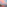 Pink sunset over coastal city beach skyline with tranquil sea reflections.