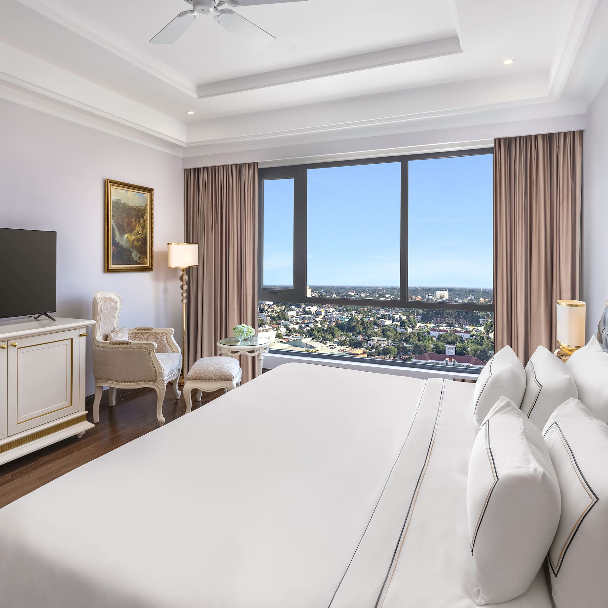 a room with a large bed and a television