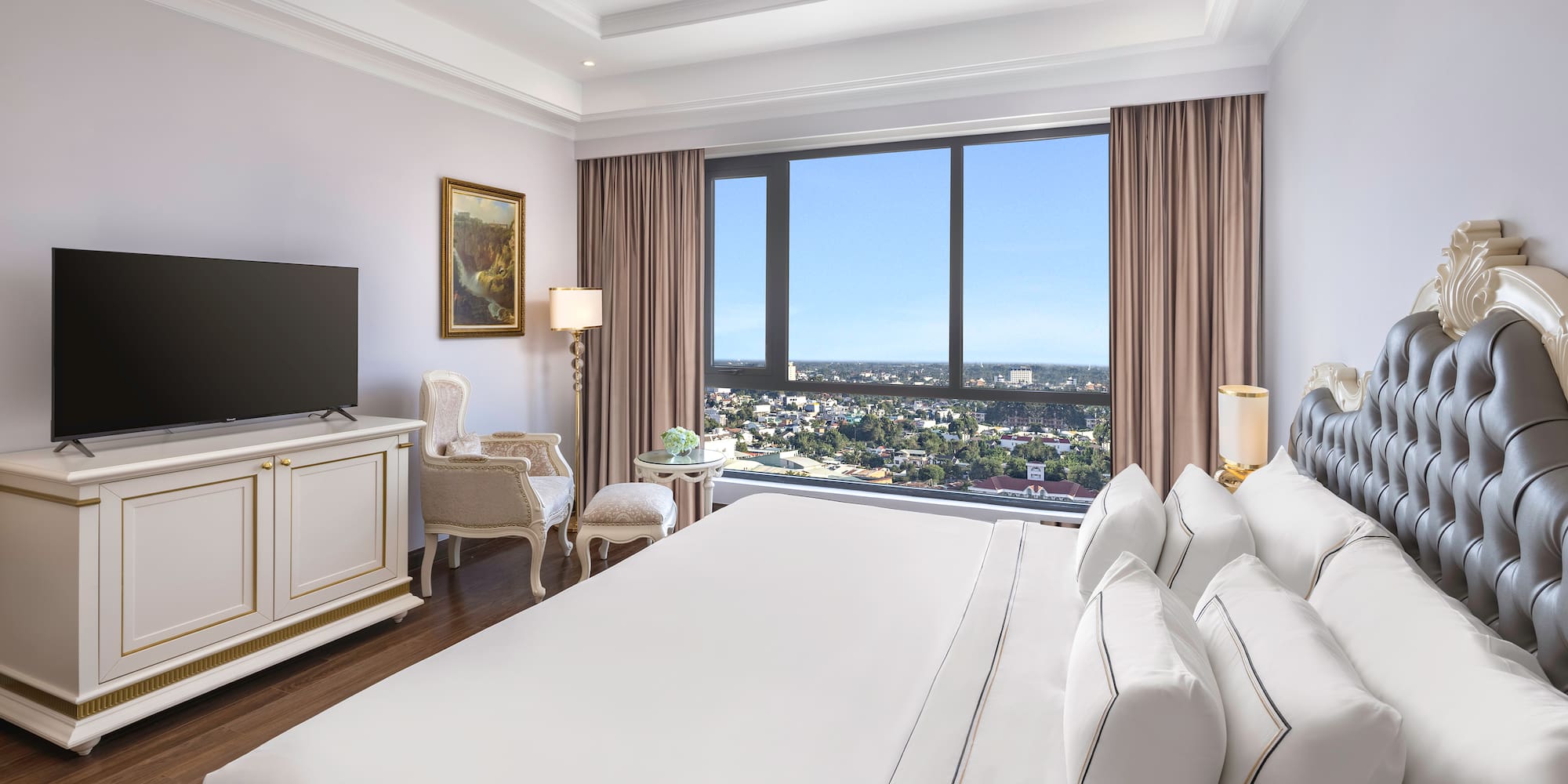 a room with a large bed and a television