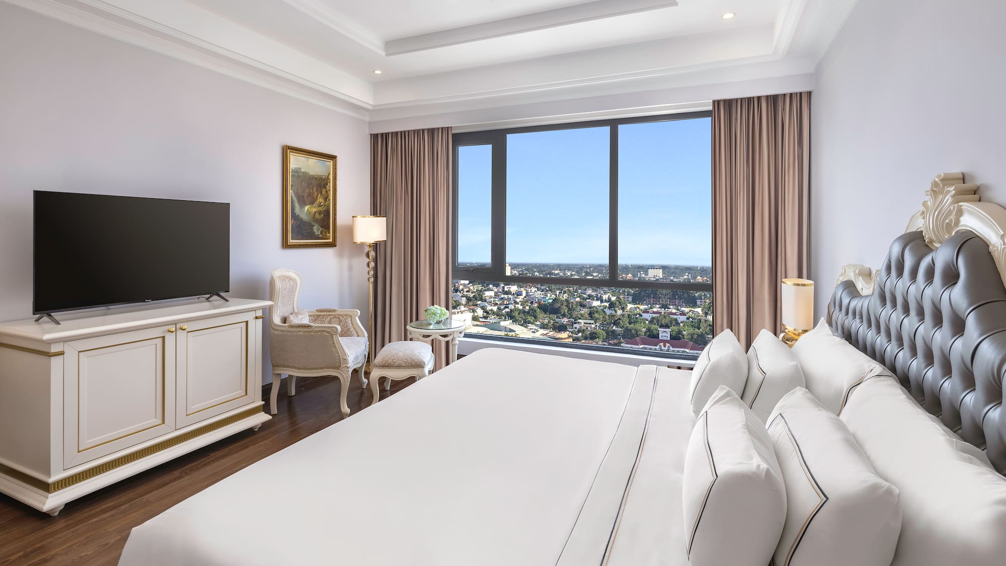 a room with a large bed and a television