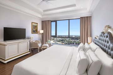 a room with a large bed and a television