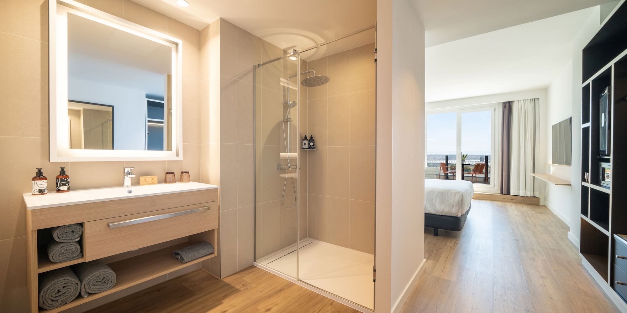 a bathroom with a shower and a wood floor