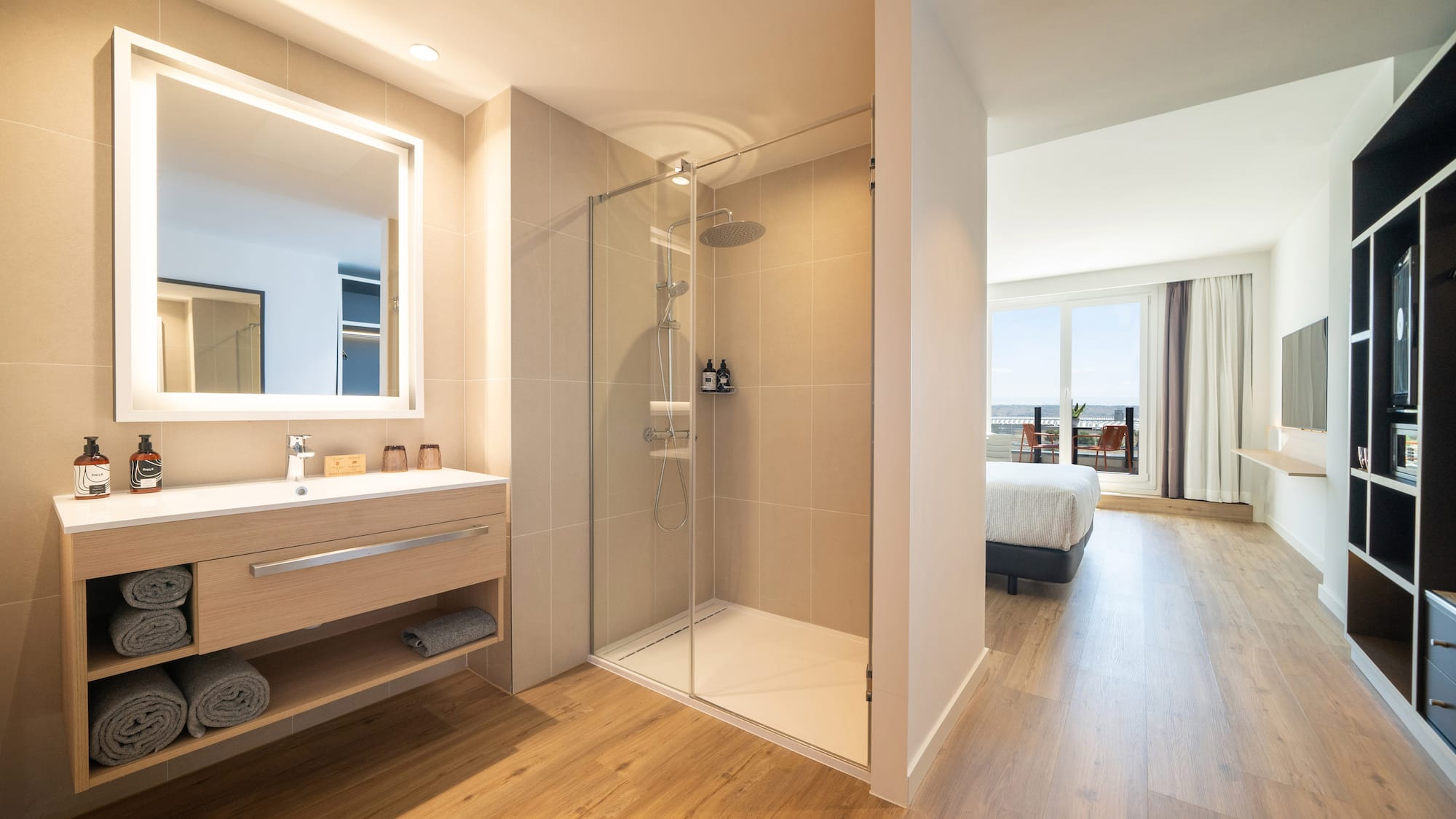 a bathroom with a shower and a wood floor