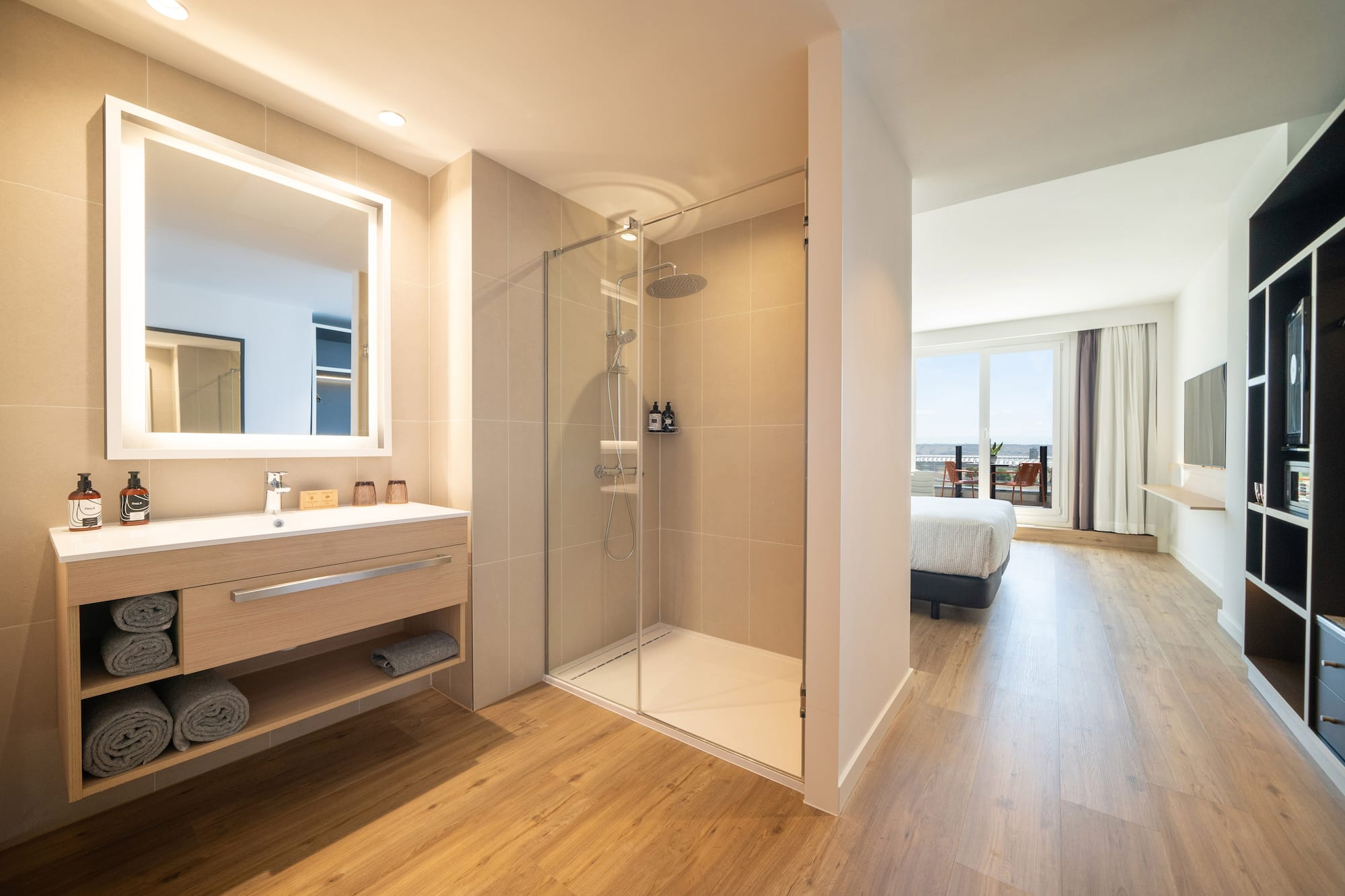 a bathroom with a shower and a wood floor