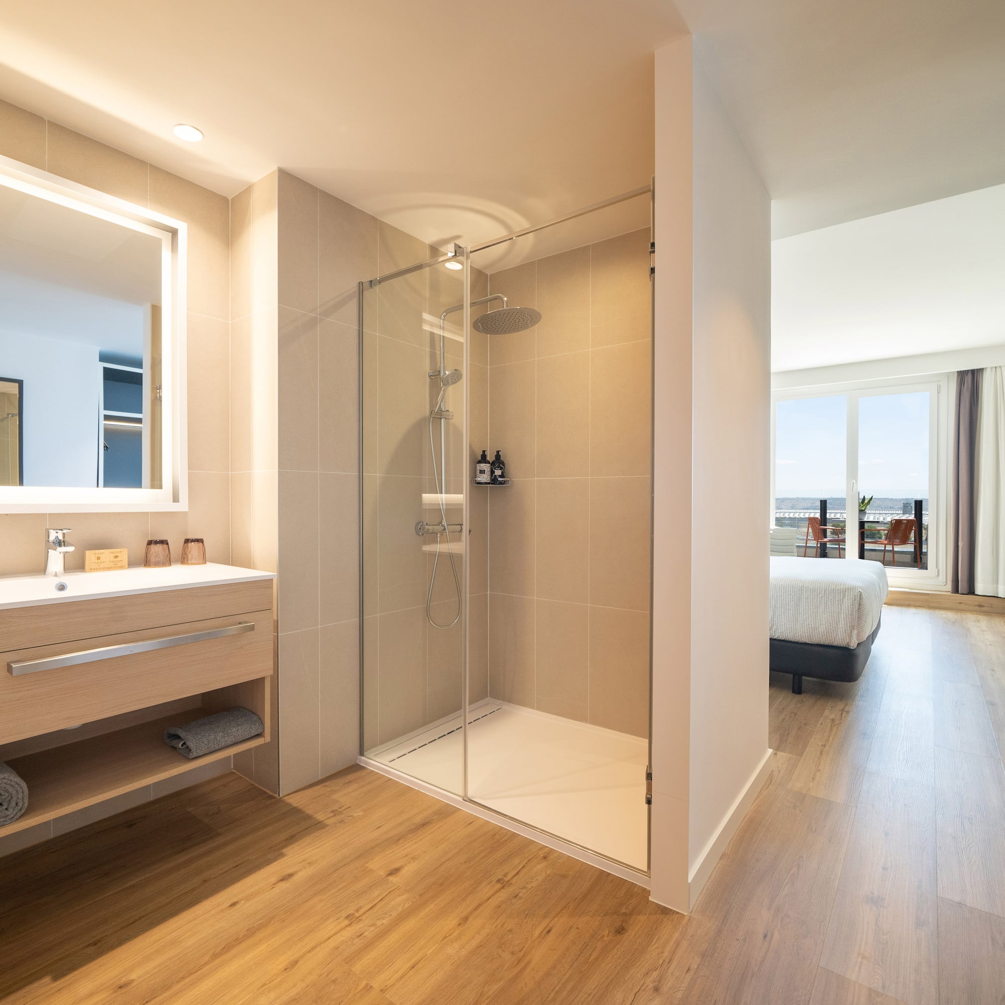 a bathroom with a shower and a wood floor