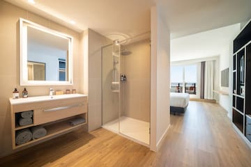 a bathroom with a shower and a wood floor