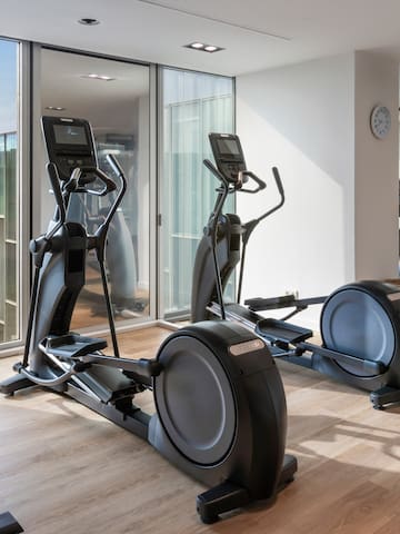 a room with exercise machines and a window