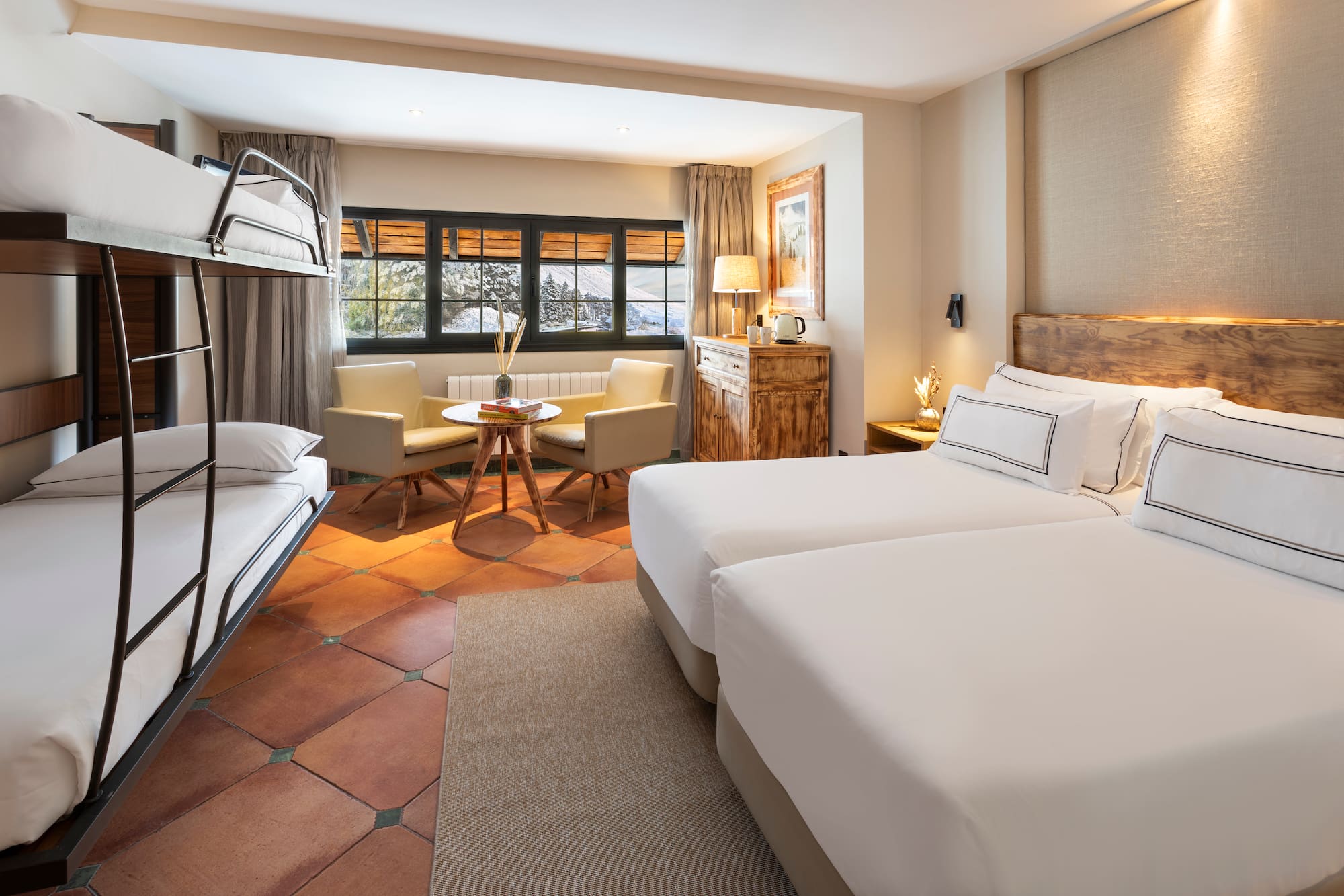 a room with two beds and a table