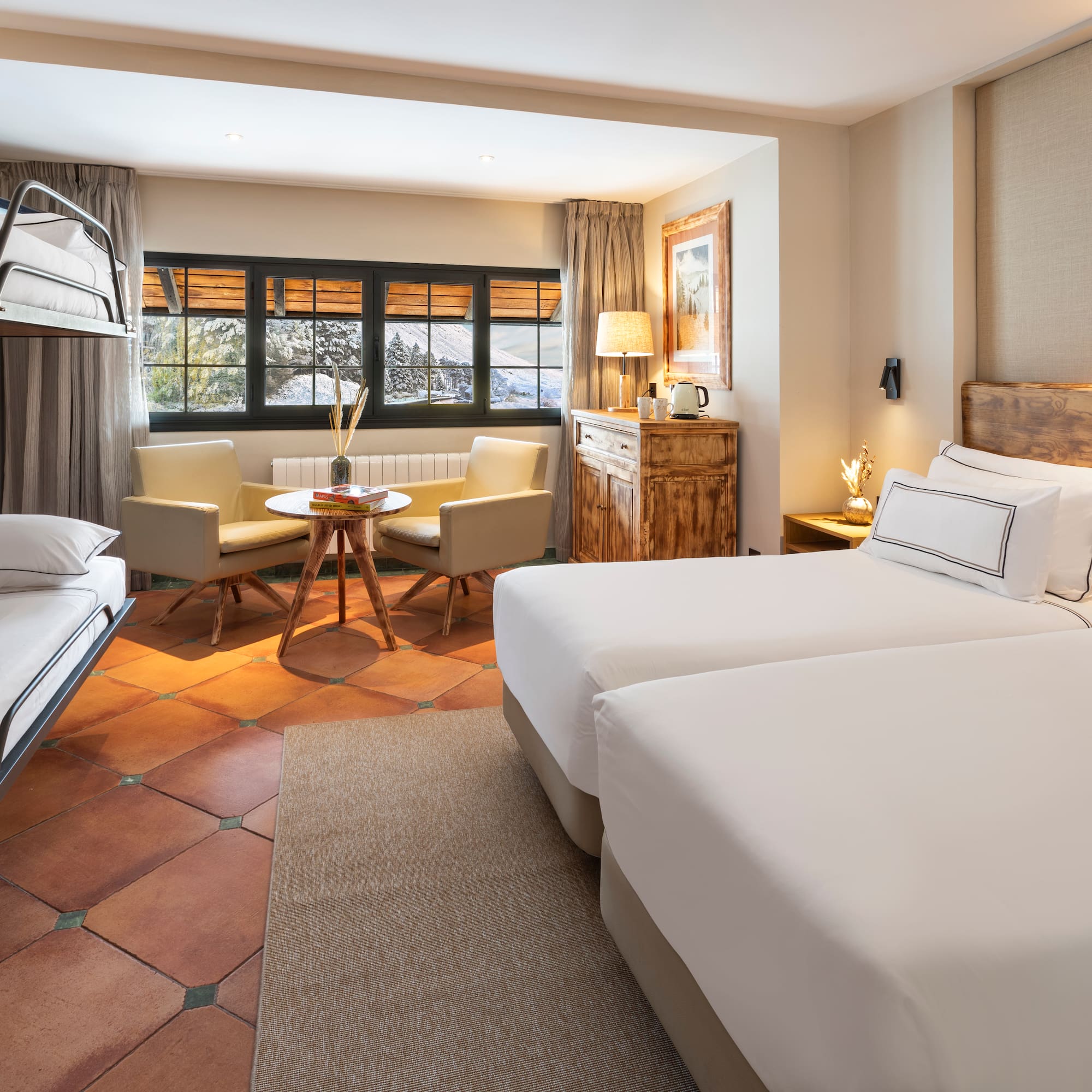 a room with two beds and a table