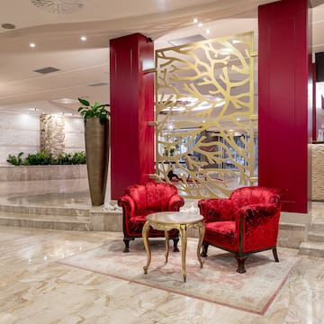 a red chairs and a table in a lobby