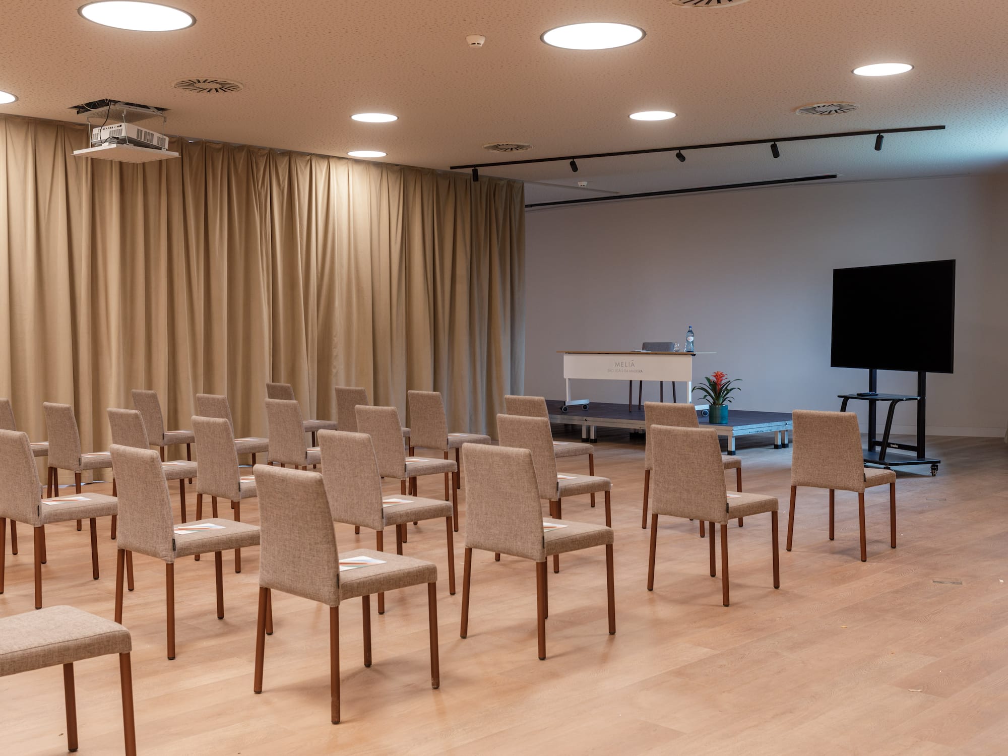 a room with chairs and a screen