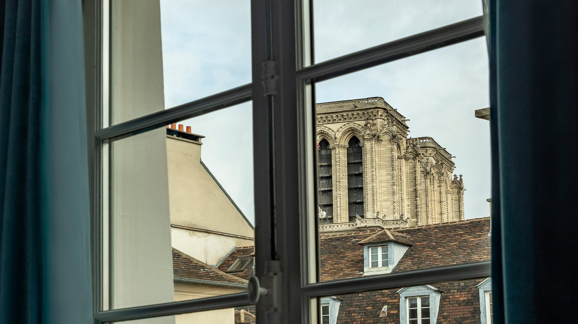 a window with a building in the background