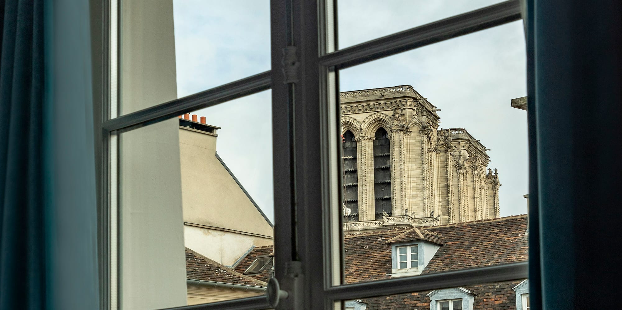 a window with a building in the background