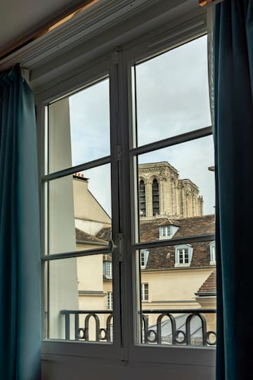 a window with a building in the background